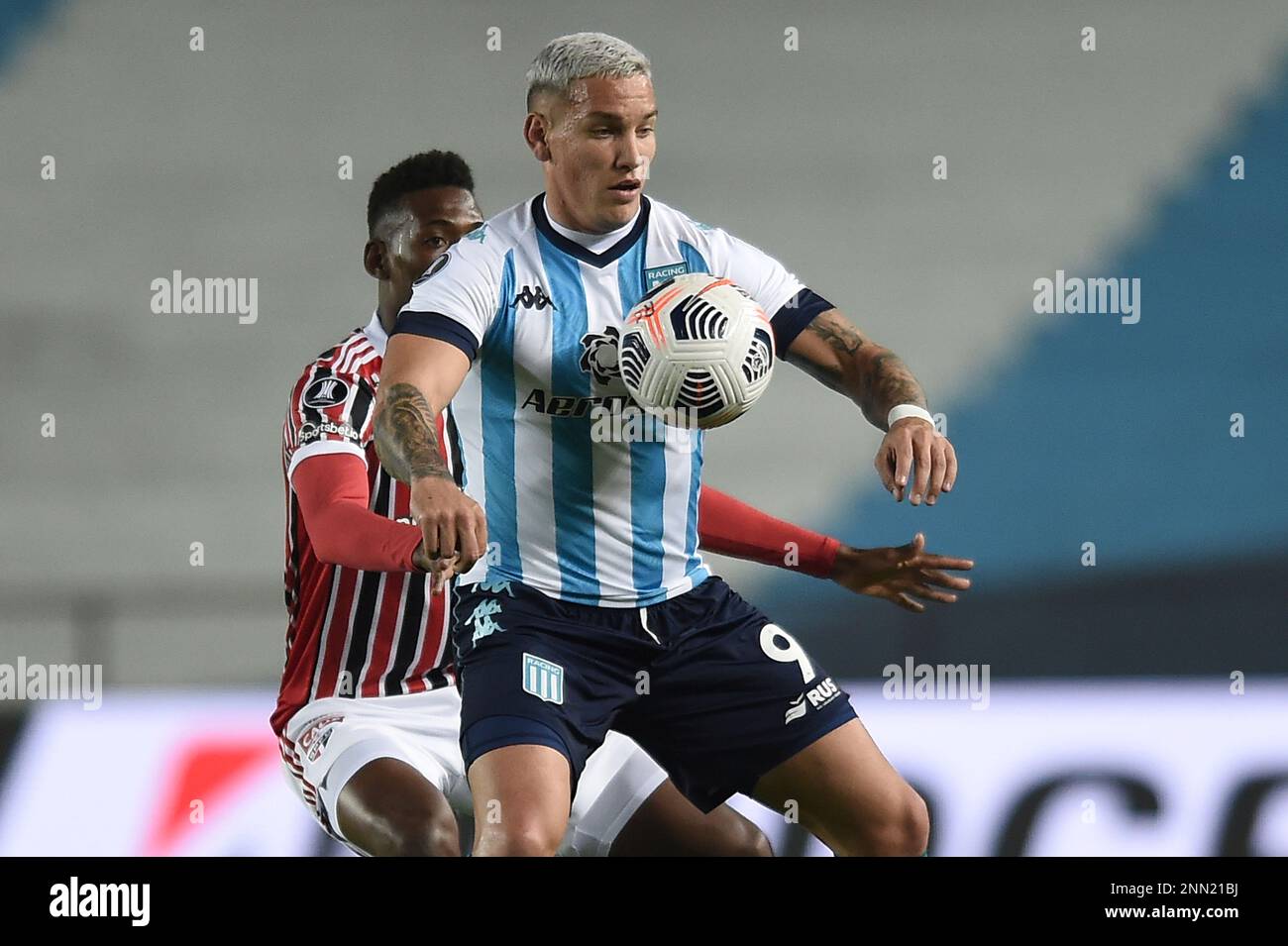 Enzo Copetti of Argentina's Racing Club, back, and Horacio