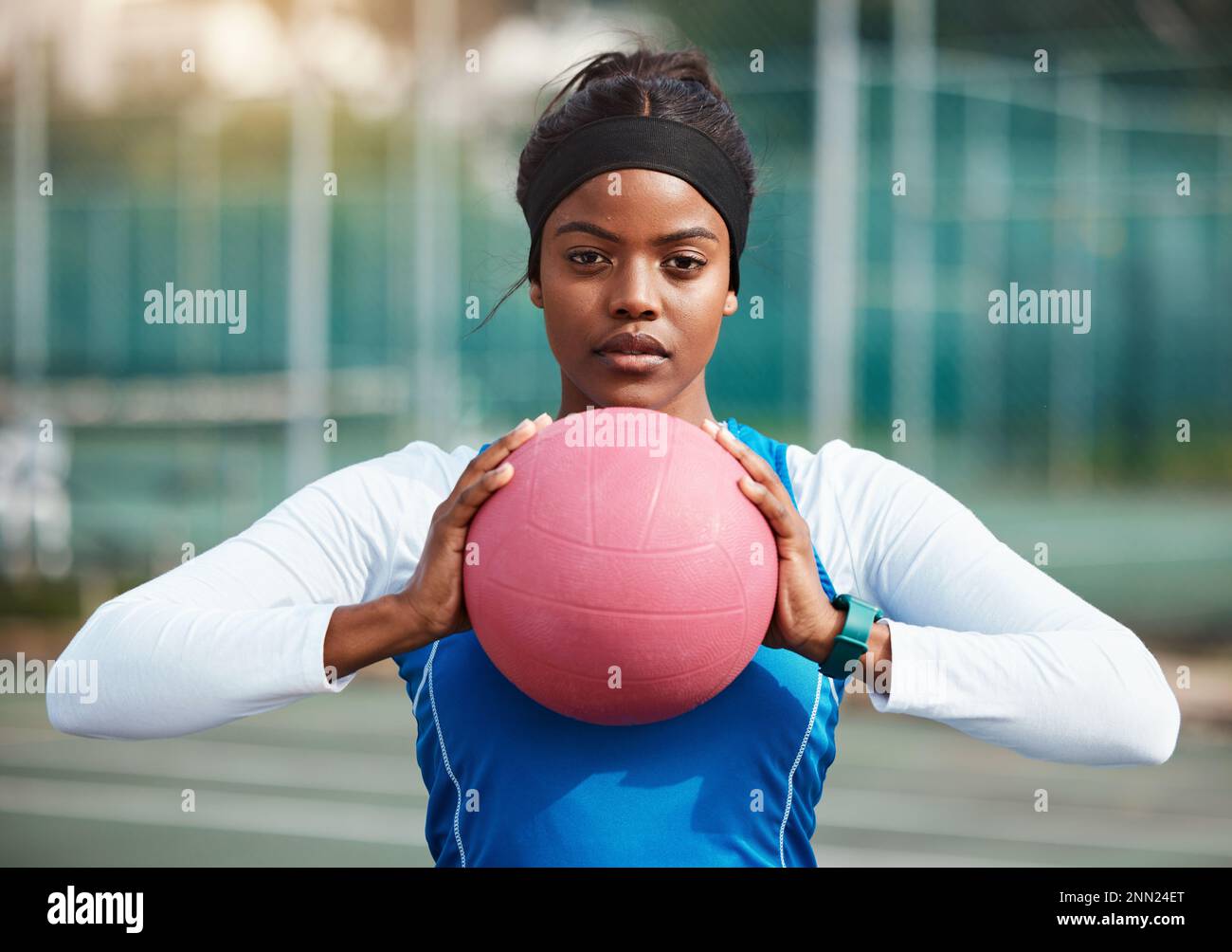 Portrait, serious black girl with netball and sports, fitness and training for game outdoor, confident teen and ready. Exercise, athlete and African Stock Photo
