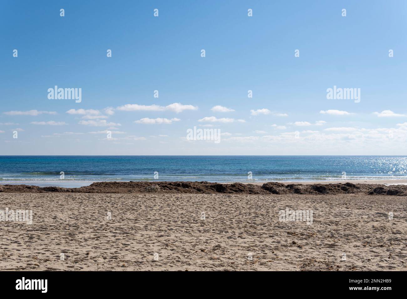 Beach of the Mallorcan tourist resort of Sa Coma at sunrise, without people. Spain Stock Photo