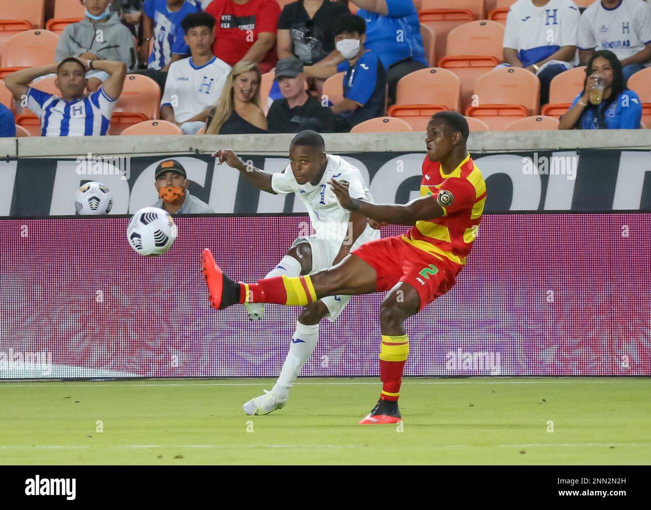 HOUSTON, TX - JULY 13: Honduras midfielder Edwin Solano (19) and Grenada  forward Benjamin Ettienne (2) fight to volley the ball during the CONCACAF  Gold Cup Group D soccer match between Honduras