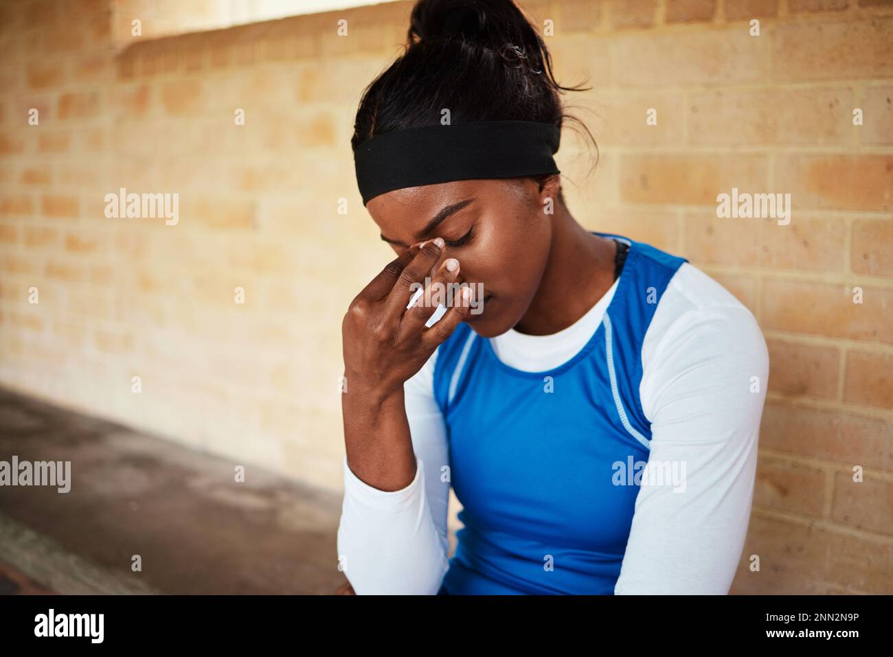 Headache, fitness and black woman in pain during run, exercise or