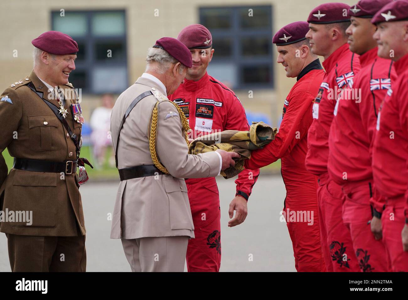 Britain's Prince Charles is presented with the parachute vest he wore