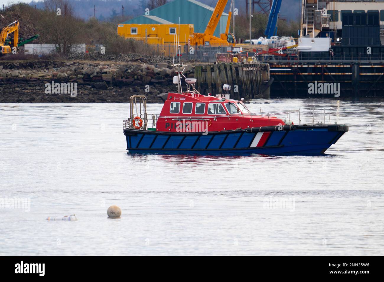 Greenock, Scotland, UK. 25 February 2023. Police and Pilot craft at scene of sinking of the Clyde Marine Services tug Biter that sunk Near East India Harbour in Greenock yesterday .   Two crew members are still missing. Pic Buoys mark the spot where the tug sank. Iain Masterton/Alamy Live News Stock Photo