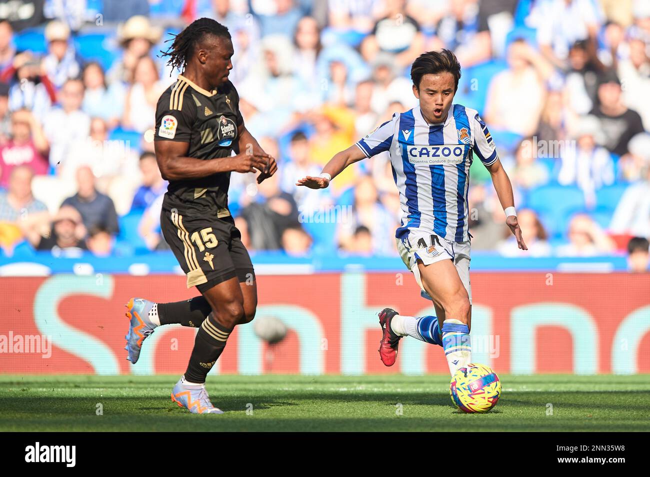 Takefusa Kubo of Real Sociedad and Joseph Aidoo of RC Celtain action during the La Liga Santander match between Real Sociedad and RC Celta CF at Reale Stock Photo