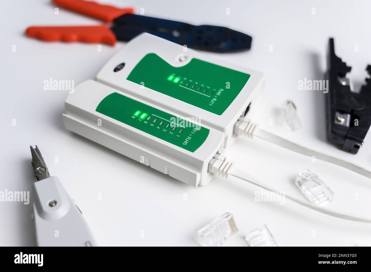 Cat6 RJ45 cable network tester. Twisted pair test tool on the desktop. Stock Photo