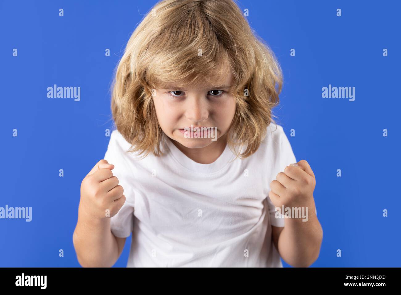 Child with angry expression. Angry hateful little boy, child furious. Angry rage kids face. Anger child with furious negative emotion portrait Stock Photo