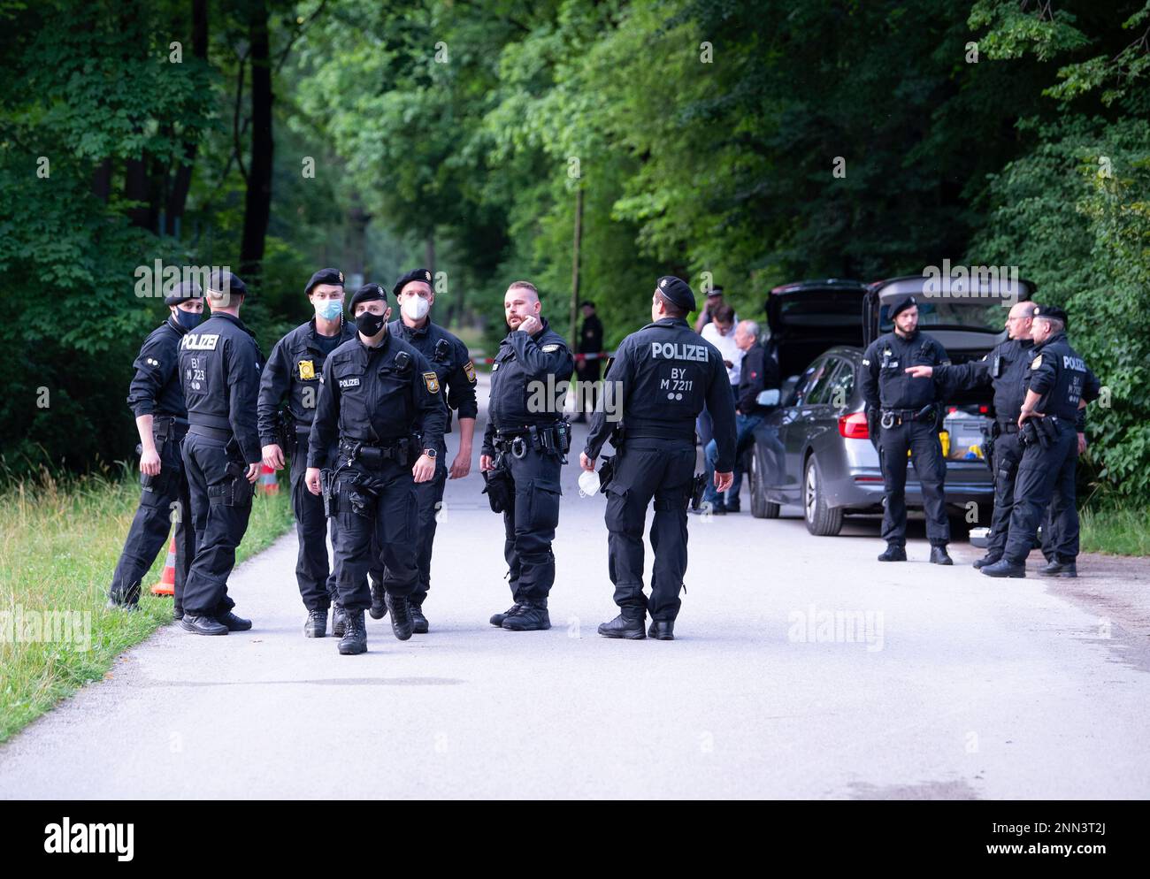 Police officers investigate a crime scene in the English Garden, in Munich,  Germany, Wednesday, July 7, 2021. A man has been shot by police officers. A  plain-clothes patrol had wanted to carry