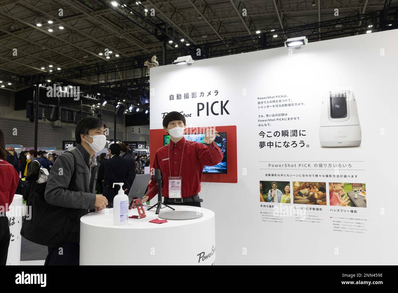 Canon exhibitor explains a visitor how Canon’s PowerShot PICK autonomous camera device is able to make photos by itself with face recognition AI software making a photographer obsolete. Pacifico Yokohama on February 24, 2023. (Photo by Stanislav Kogiku / SOPA Images/Sipa USA) Stock Photo
