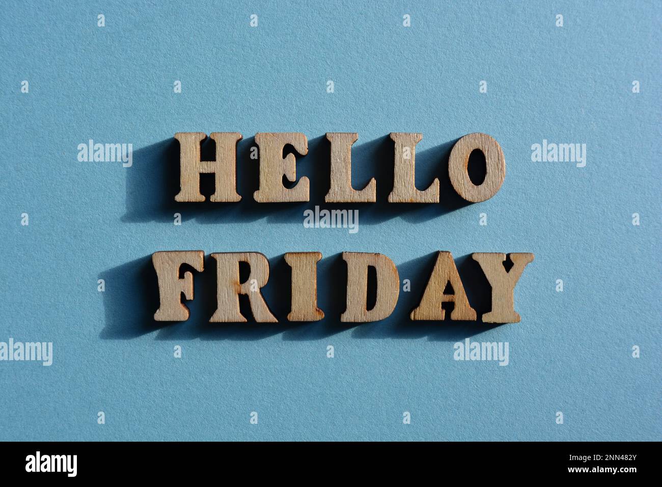 Hello Friday, words in wooden alphabet letters isolated on blue background as banner headline Stock Photo