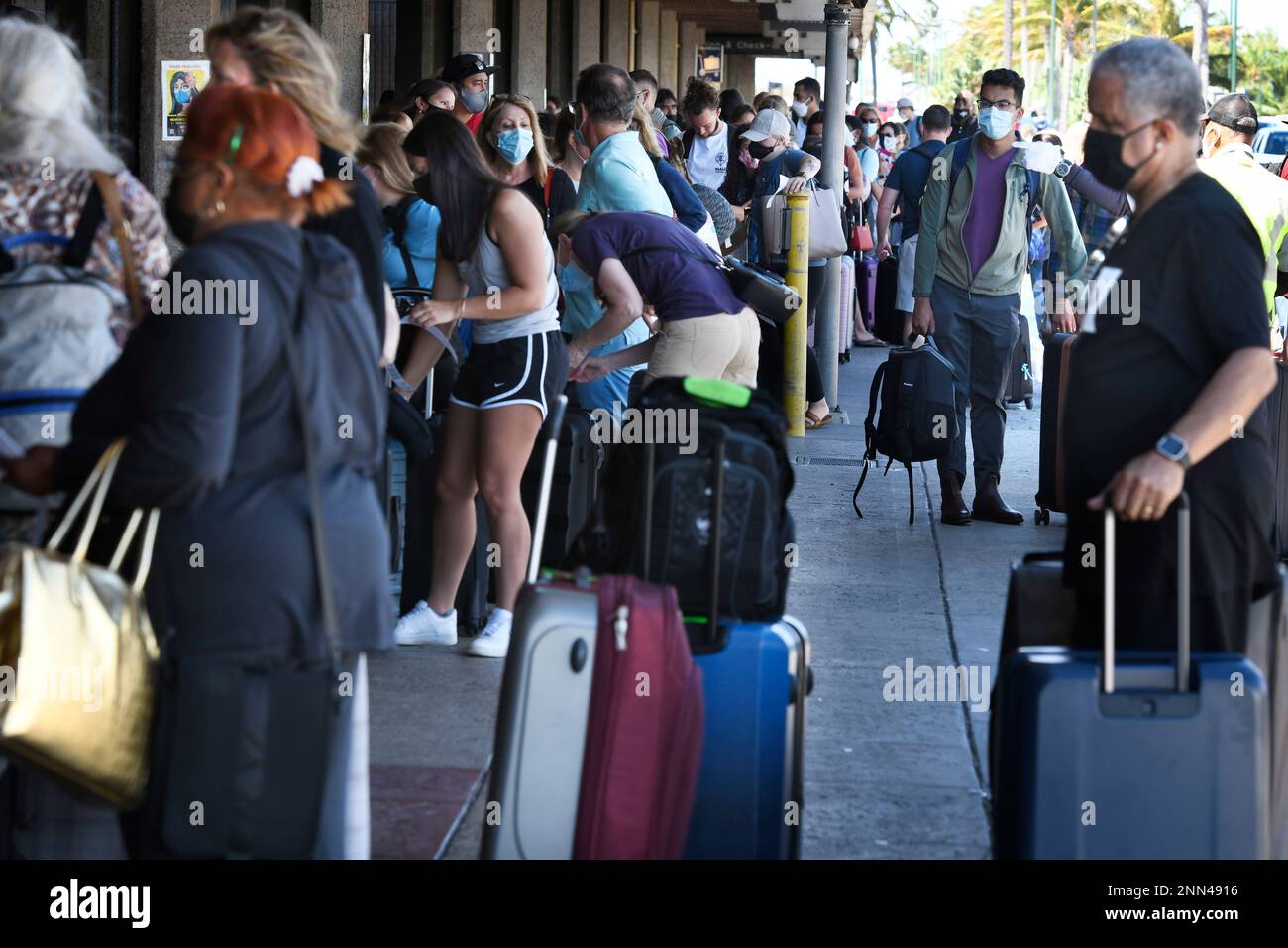 A long line of travelers wait to pass through a state agriculture