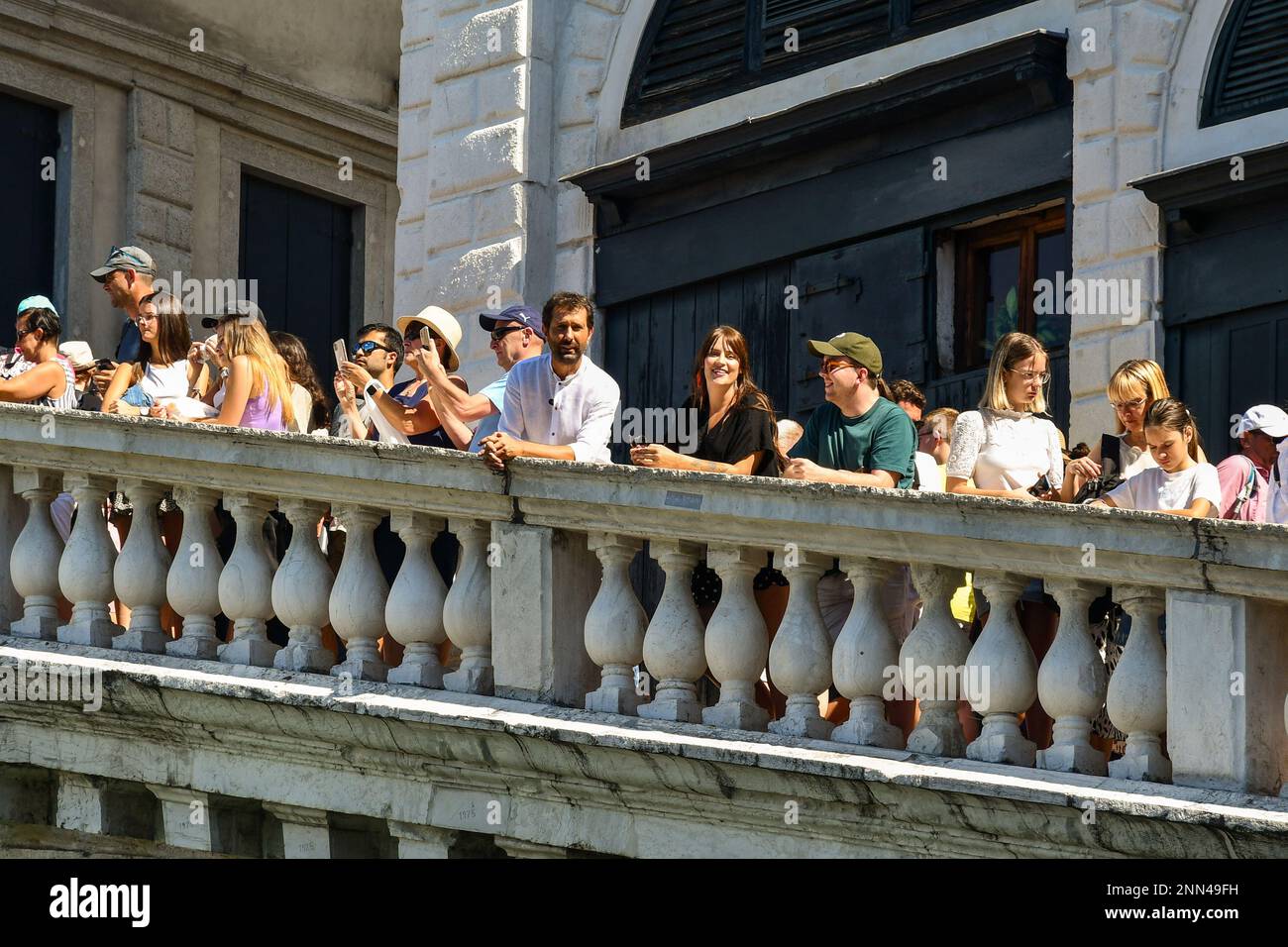 The TV presenter Marco Di Buono on the Rialto Bridge crowded with tourists during a Rai service, Venice, Veneto, Italy Stock Photo