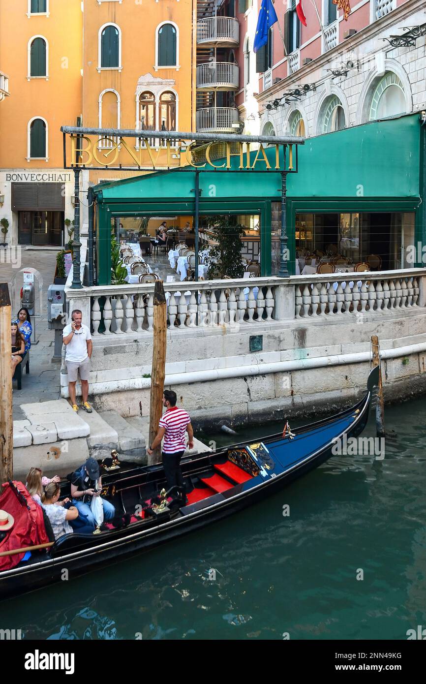 High-angle view of a gondola with tourists moored on Rio dei Fuseri canal in summer, St Mark's district, Venice, Veneto, Italy Stock Photo