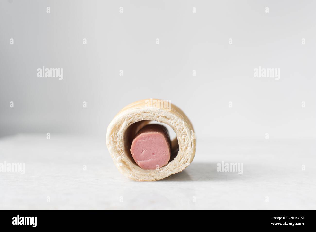 Sausage roll on a marble tray, twisted sausage roll on a marble tray, Large pigs in a blanket