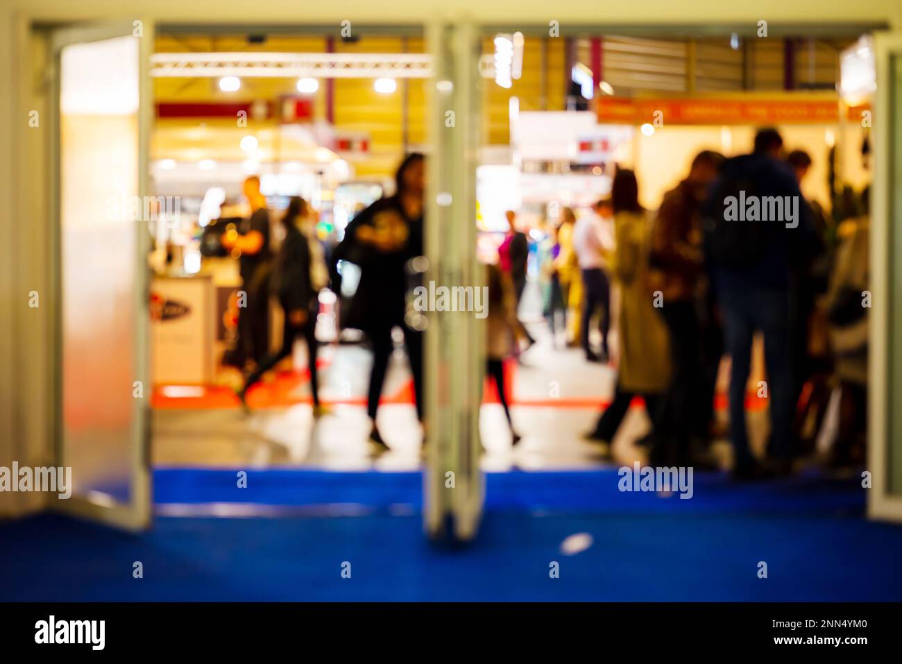 Entrance to Exhibition. Blurred Shot Of People Walking Indoors At Food And Food Technology Exhibition, Riga, Latvia. Stock Photo