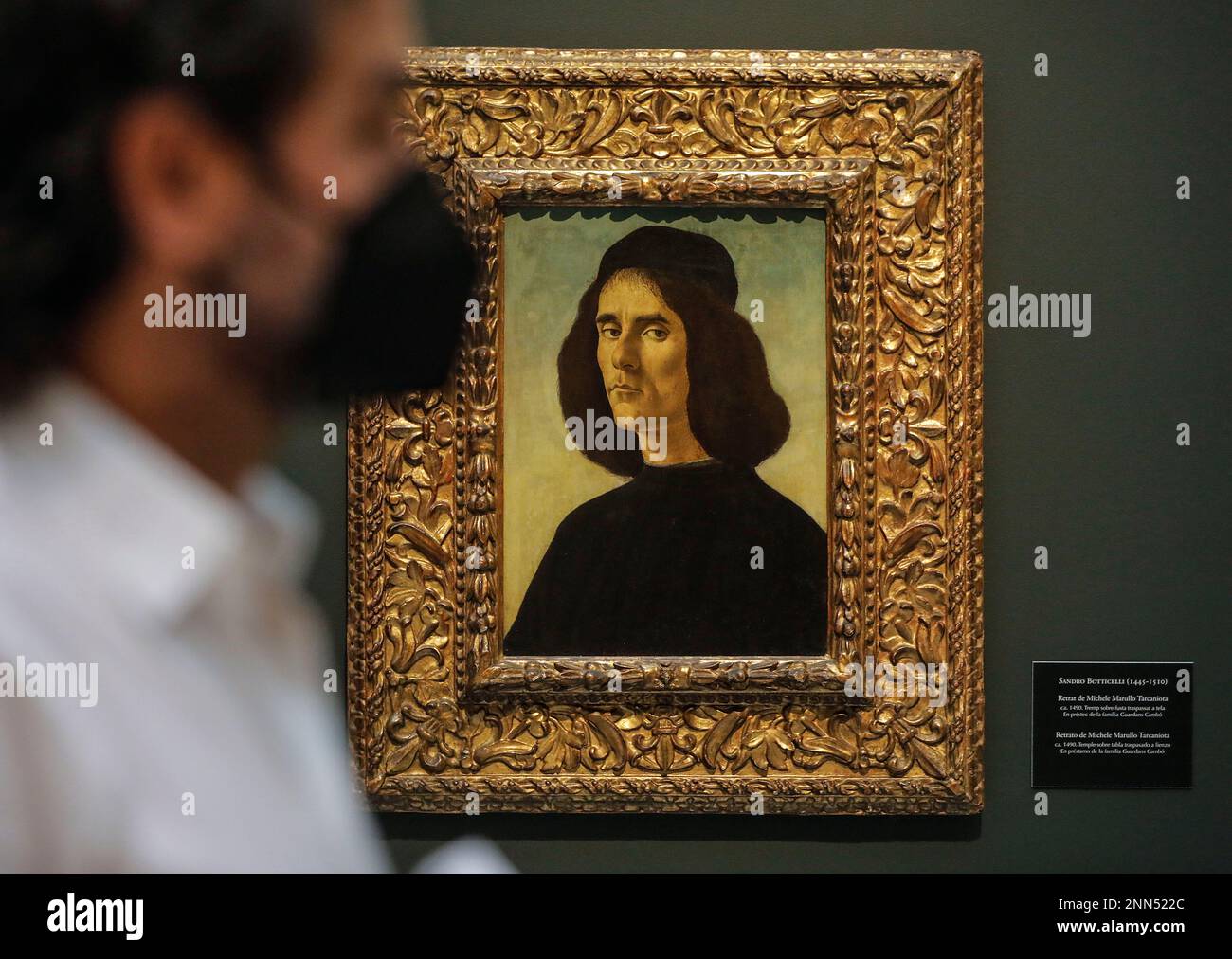 A person walks past Portrait of Michele Marullo Tarcaniota by