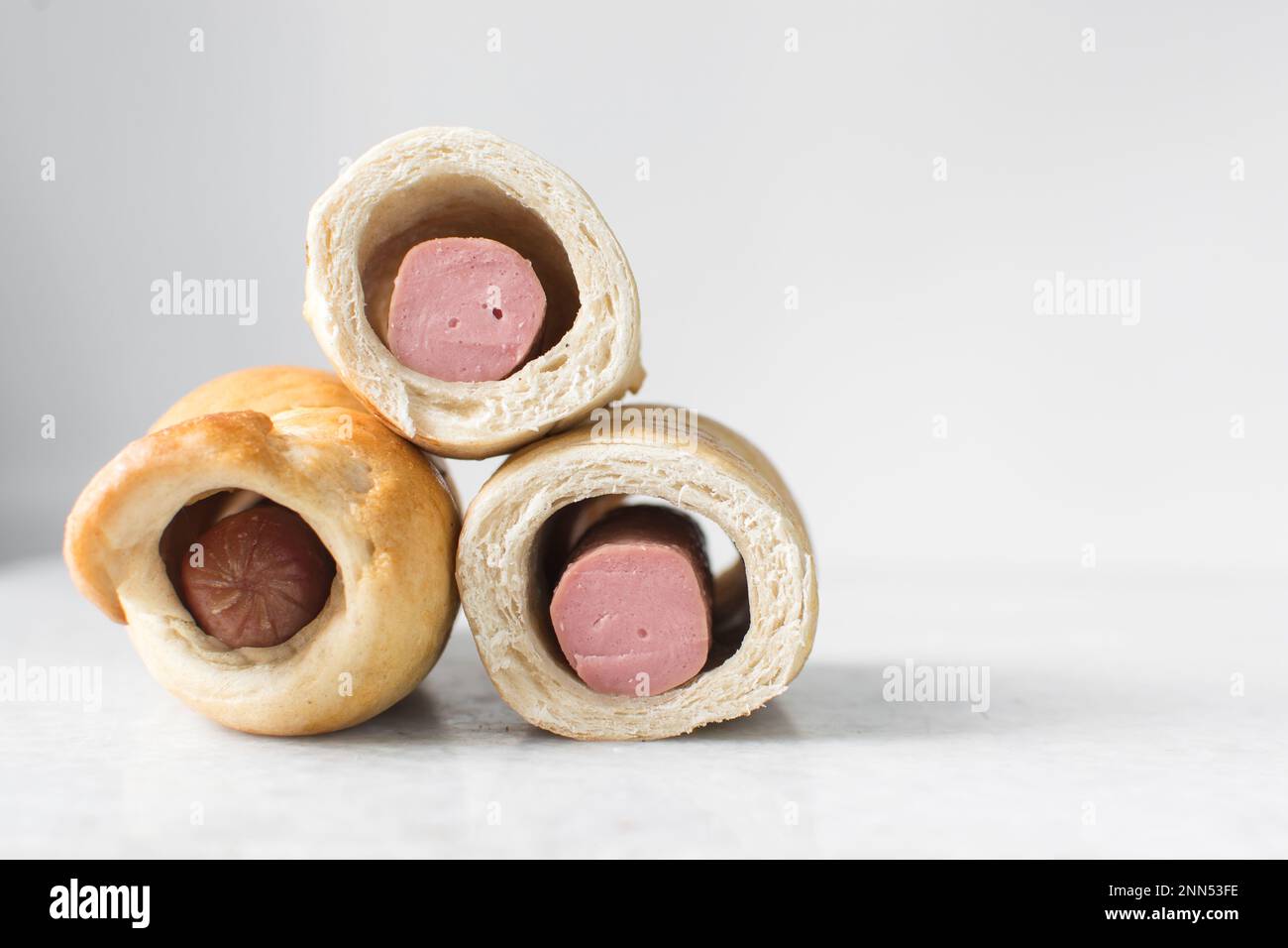 Sausage roll on a marble tray, twisted sausage roll on a marble tray, Large pigs in a blanket