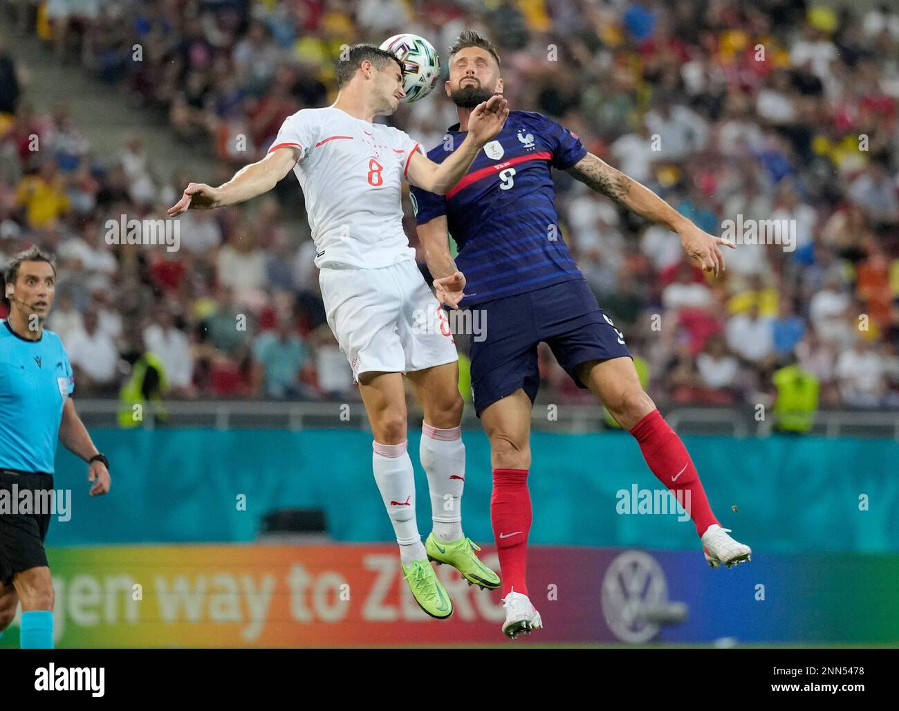 Switzerland's Remo Freuler, left, and France's Olivier Giroud head the ball  during the Euro 2020 soccer championship round of 16 match between France  and Switzerland at the National Arena stadium in Bucharest,