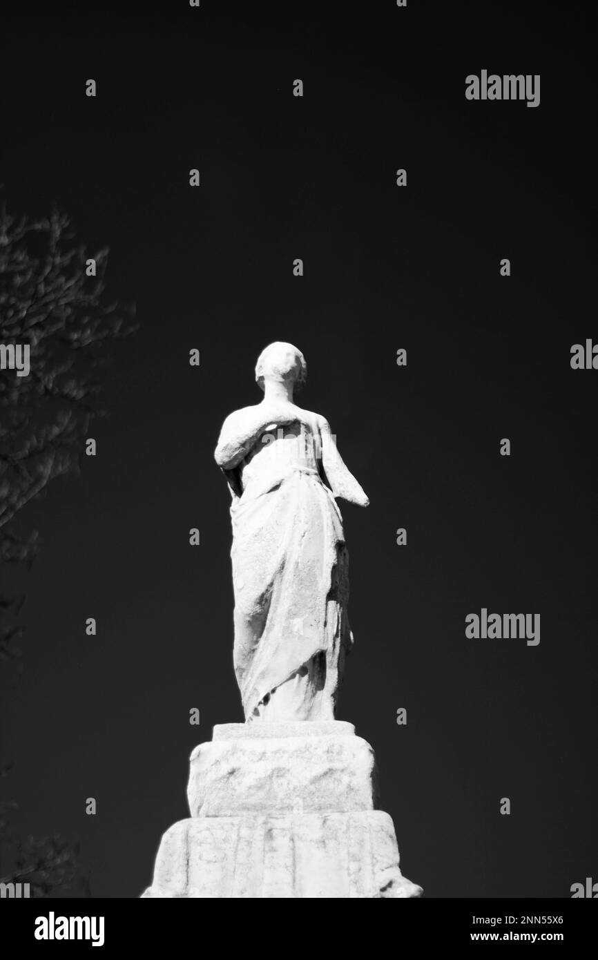 A Statue Of A Beautiful Woman Walking Tall In A Black And White