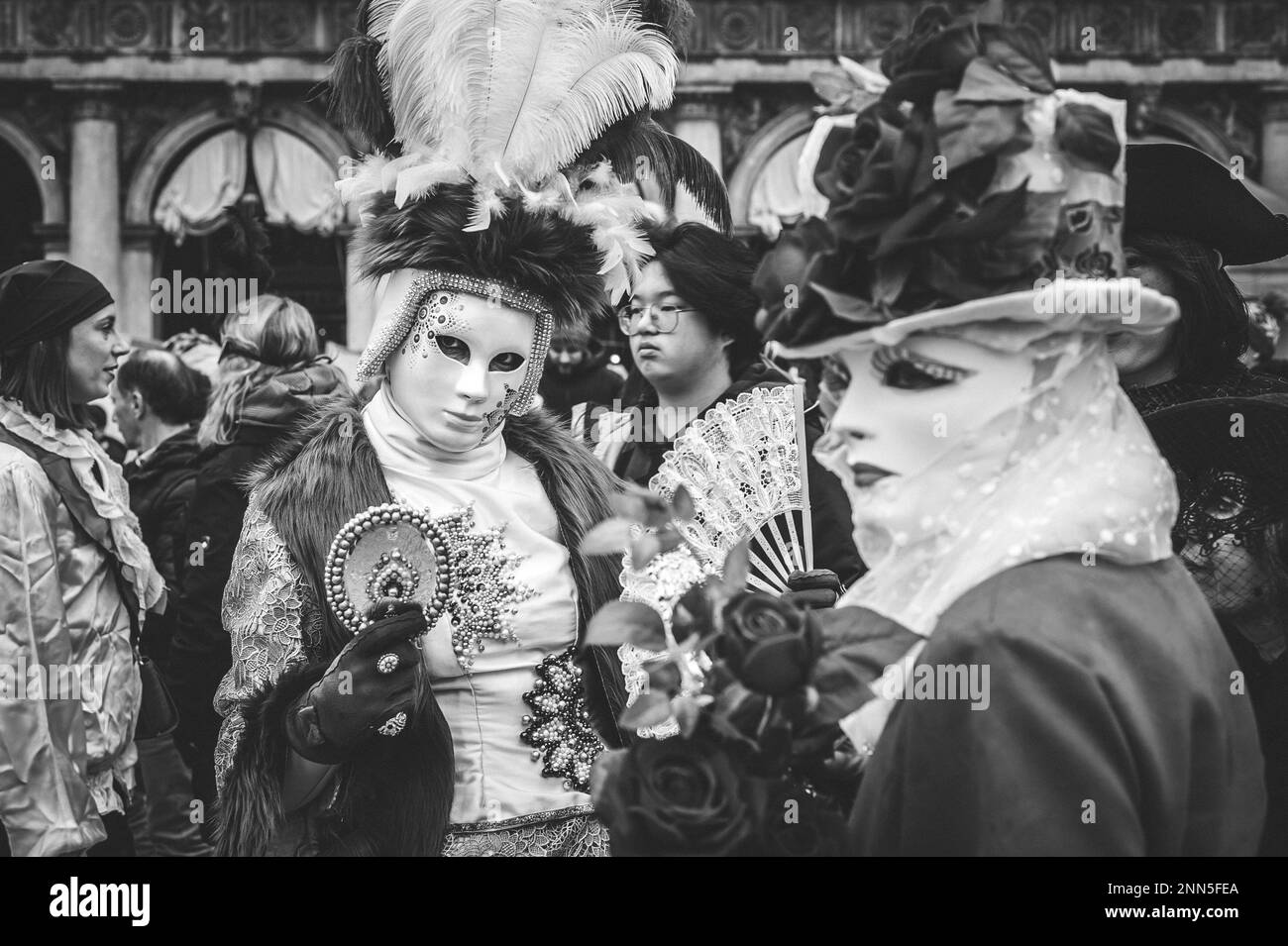 B/W portrait of a couple of carnival masked women in Venice Stock Photo