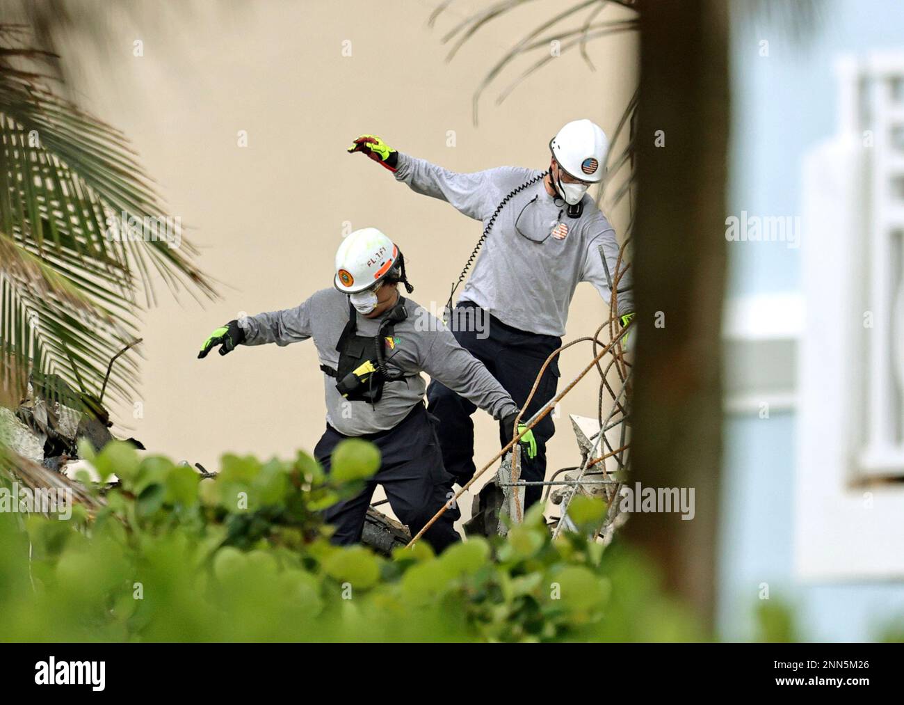 Search and rescue personnel search for survivors through the rubble at ...