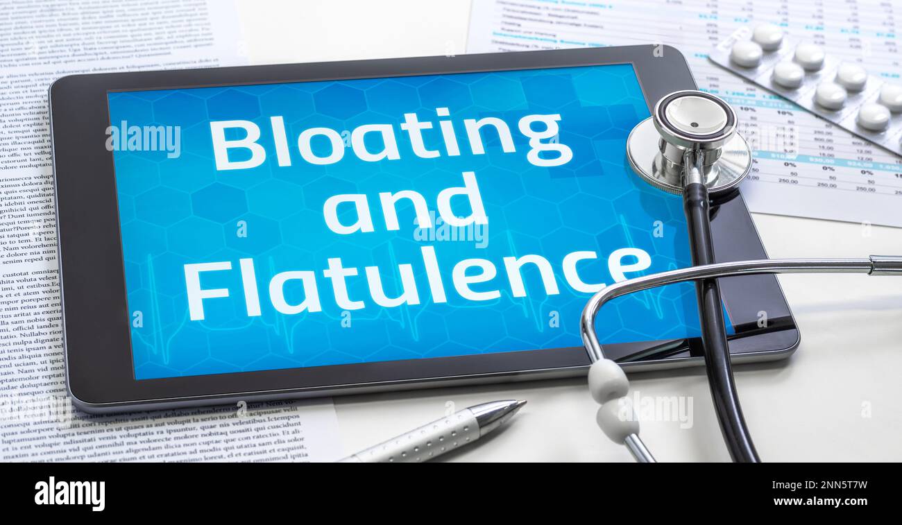 The word Bloating and Flatulence on the display of a tablet Stock Photo