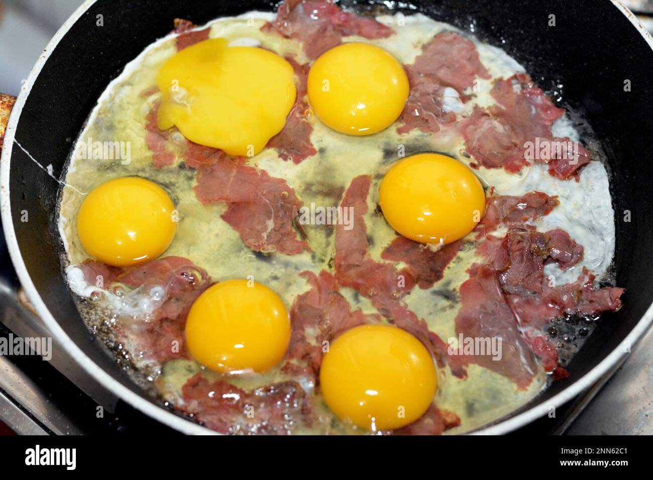 Eggs to be scrambled with pastrami, a dish made from eggs stirred