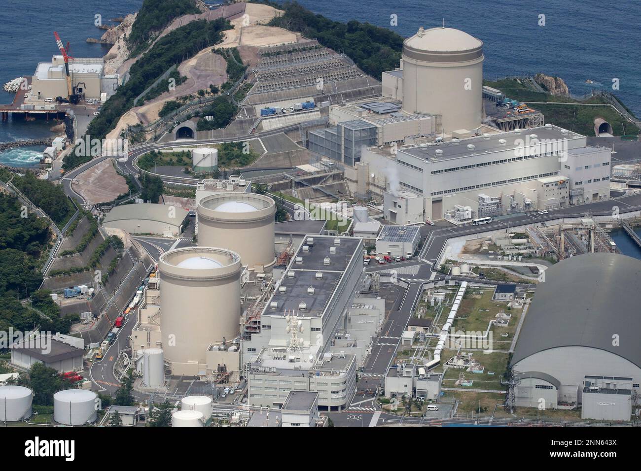 An aerial photo shows Mihama Nuclear Power Plant Unit 3 (R) which