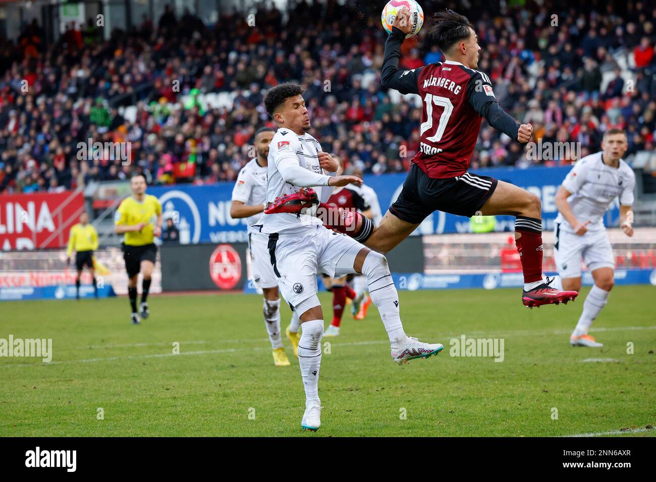 Germany. 25th Feb, 2023. Nuremberg, Germany. 25th Feb, 2023. Soccer: 2nd Bundesliga, 1. FC Nürnberg - SV Sandhausen, Matchday 22, Max-Morlock-Stadion. Sandhausen's Chima Okoroji (l-r) and Nuremberg's Jens Castrop fight for the ball. Credit: Daniel Löb/dpa - IMPORTANT NOTE: In accordance with the requirements of the DFL Deutsche Fußball Liga and the DFB Deutscher Fußball-Bund, it is prohibited to use or have used photographs taken in the stadium and/or of the match in the form of sequence pictures and/or video-like photo series./dpa/Alamy Live News Credit: dpa picture alliance/Alamy Live News Stock Photo