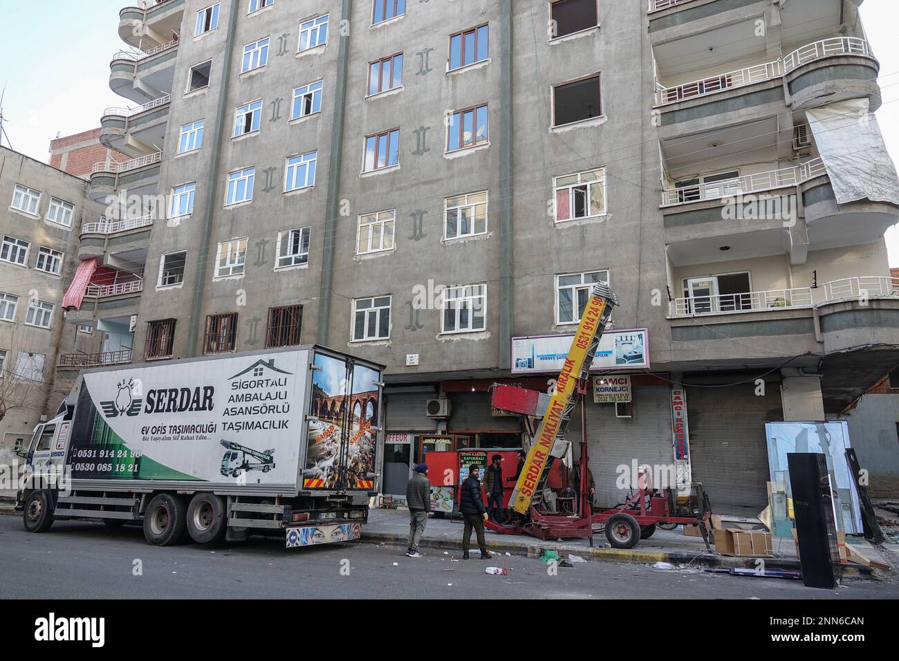 Household items are seen being moved from a building damaged by an earthquake in Diyarbakir. Due to severe earthquakes in Diyarbakir, 7 buildings were completely collapsed and destroyed, a total of 407 people died and around 900 people were injured. After the earthquake, 45 thousand 149 buildings in Diyarbak?r were checked. It has been determined that 1110 buildings, in which 8,284 families live, are heavily damaged, and these buildings will be demolished immediately. It was determined that 1044 buildings, in which 12 thousand 106 families lived, were moderately damaged, and 10 thousand 977 bu Stock Photo
