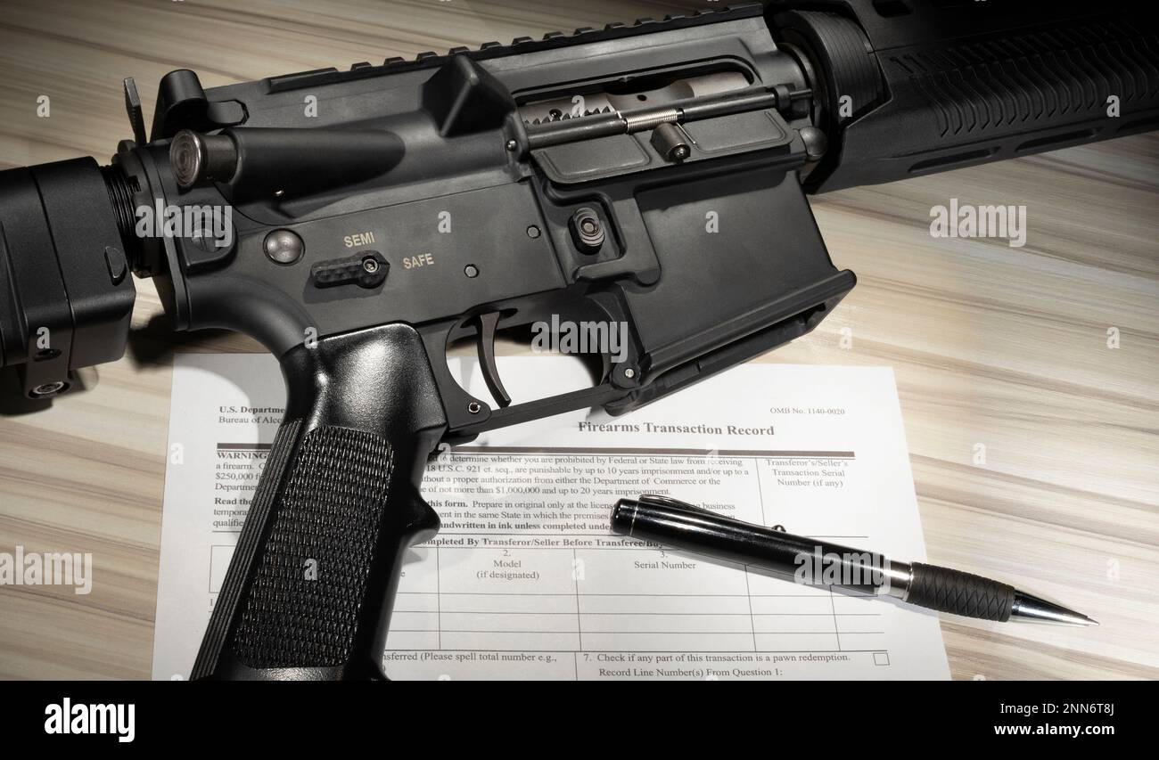 Assault rifle with public domain fbi background check form and pen