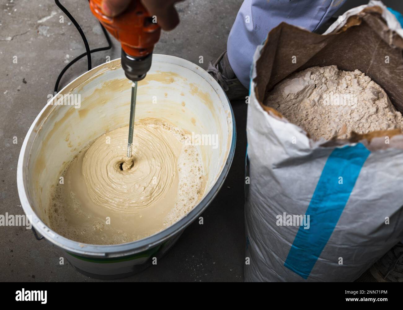 Craftsman mixing materials for wall renovation plaster Stock Photo Alamy
