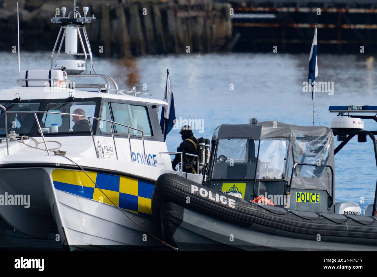 Greenock, Scotland, UK. 25 February 2023. Police and Pilot craft at scene of sinking of the Clyde Marine Services tug Biter that sunk Near East India Harbour in Greenock yesterday .   Two crew members are still missing. Buoys mark the spot where the tug sank. Iain Masterton/Alamy Live News Stock Photo