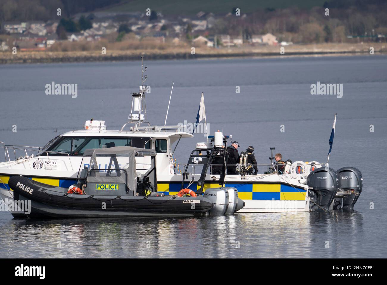 Greenock, Scotland, UK. 25 February 2023. Police and Pilot craft at scene of sinking of the Clyde Marine Services tug Biter that sunk Near East India Harbour in Greenock yesterday .   Two crew members are still missing. Pic; Police divers are working above the sunken tug.  Iain Masterton/Alamy Live News Stock Photo