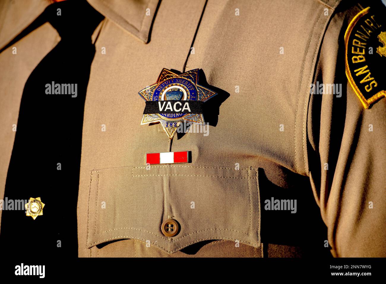 A San Bernardino County Sheriff's deputy wears a black band in honor of