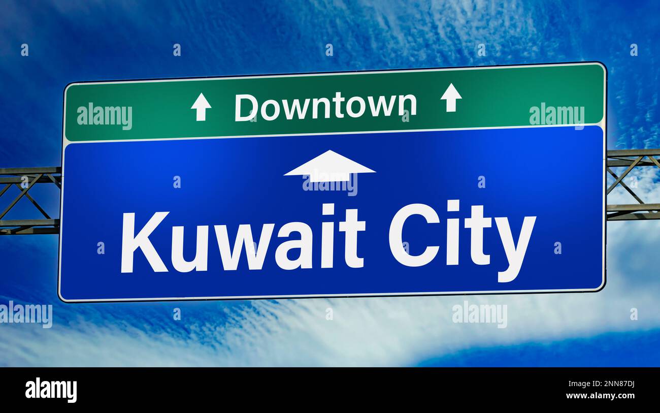 Road sign indicating direction to the city of Kuwait City. Stock Photo