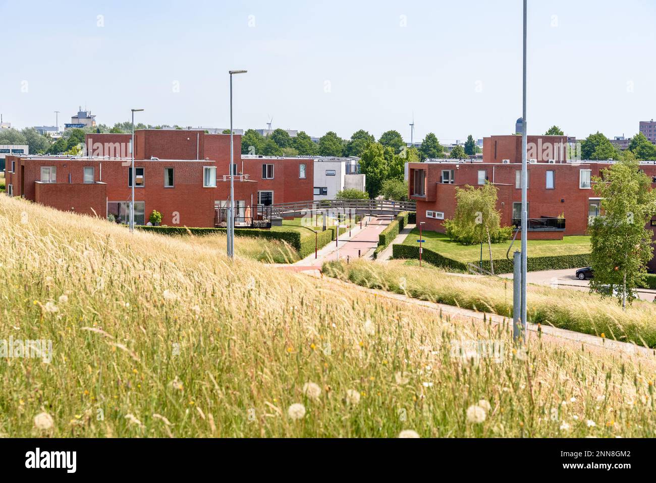 View of housing development with moder brick houses on a sunny summer day Stock Photo
