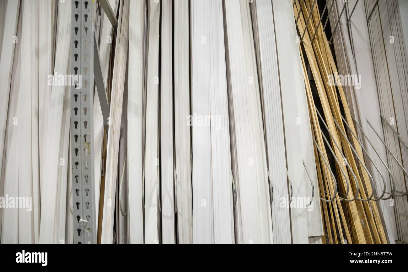 A selection of white wood or mdf baseboard and trim molding pieces for