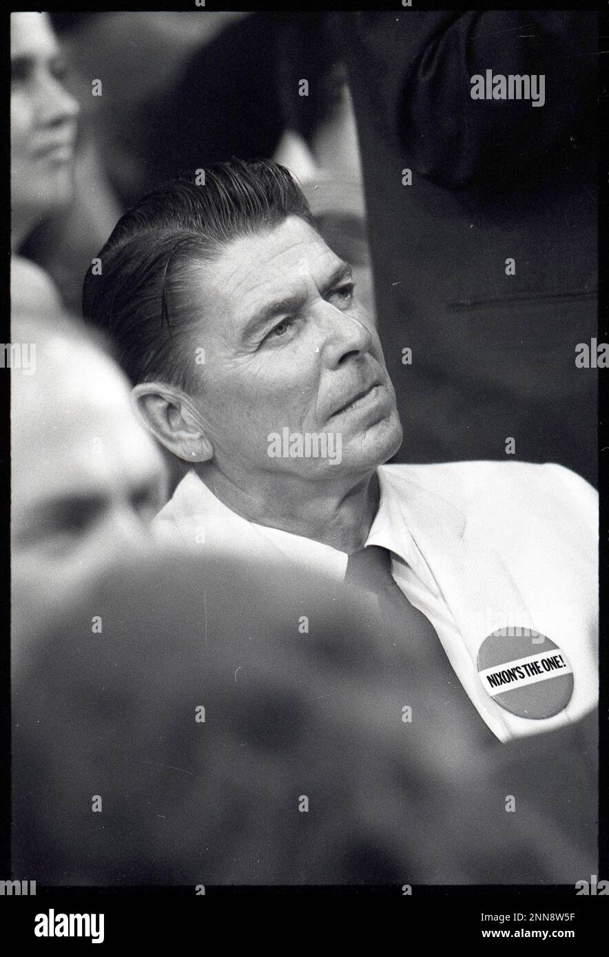 Photograph of an attentive Governor Ronald Reagan of CA wearing a Nixon's The One button at the 1968 Republican Convention, Miami, FL, 8/1968. ( Photo by United States Information Agency Stock Photo