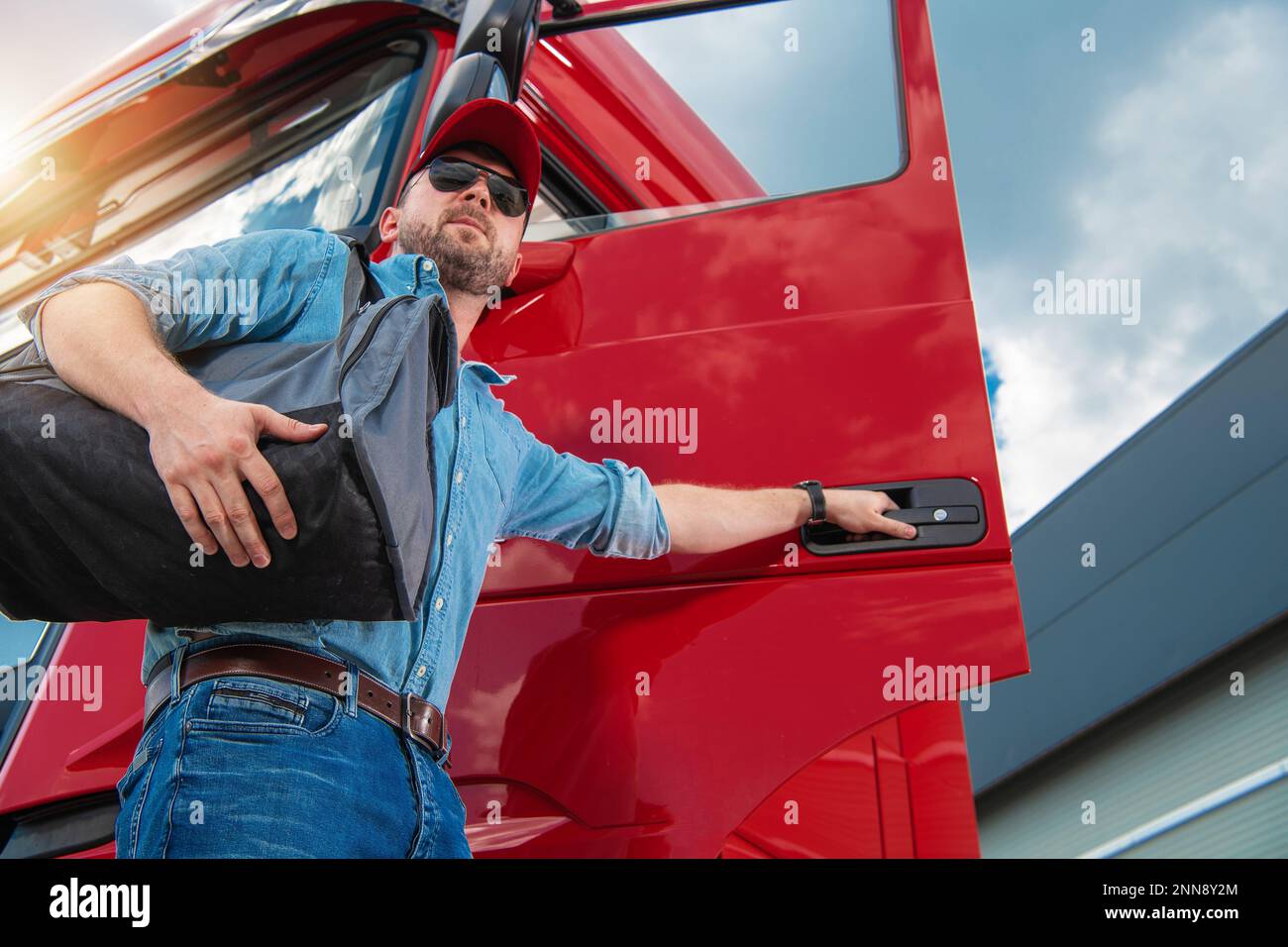 Professional Truck Driver with Travel Bag on His Shoulder Opening the ...