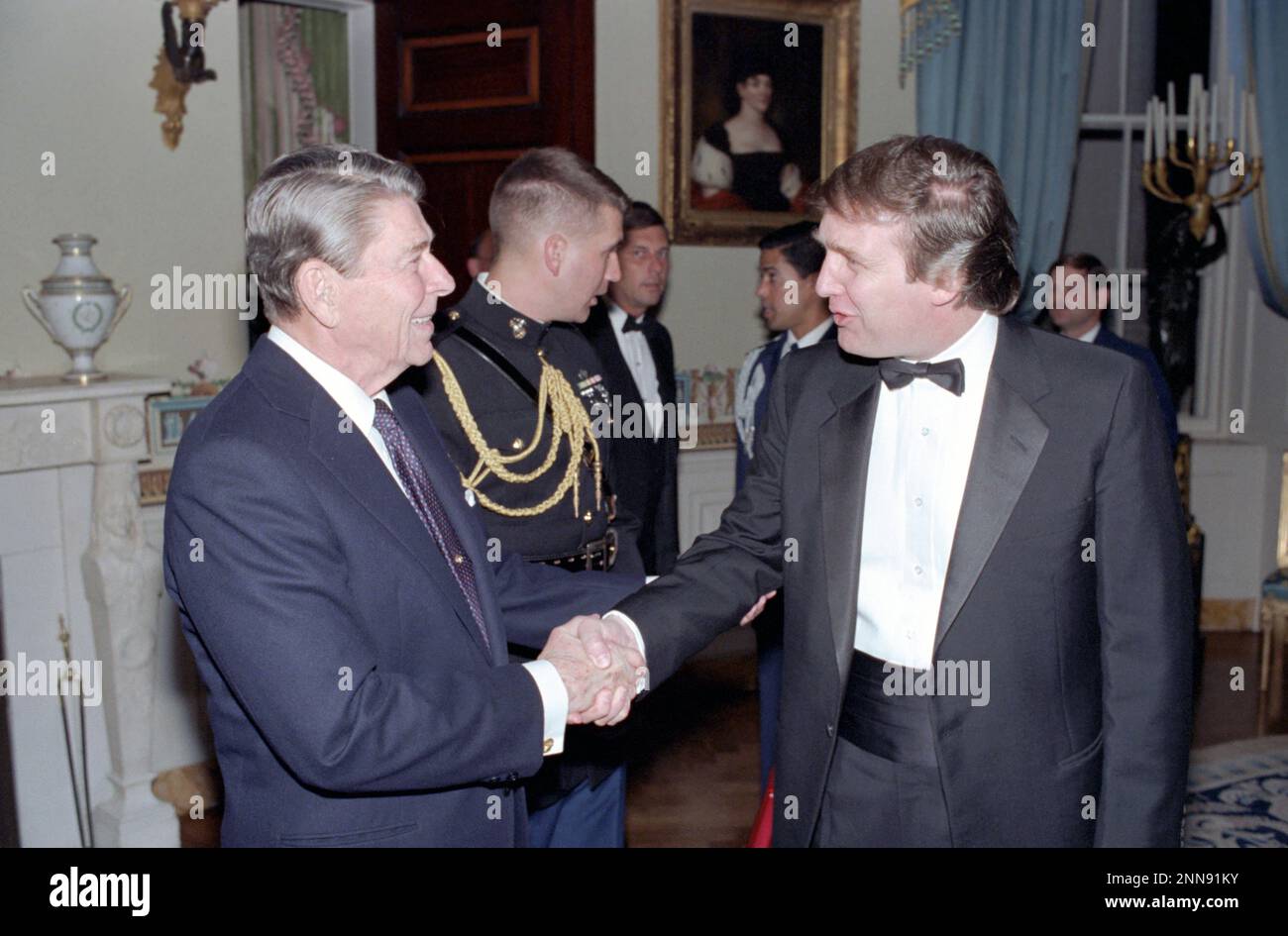 President Ronald Reagan shakes hands with Donald Trump at a reception for members of the 'Friends of Art and Preservation in Embassies' Foundation in the White House's Blue Room, Washington, DC, 11/3/1987. (Photo by White House Photo Office Stock Photo