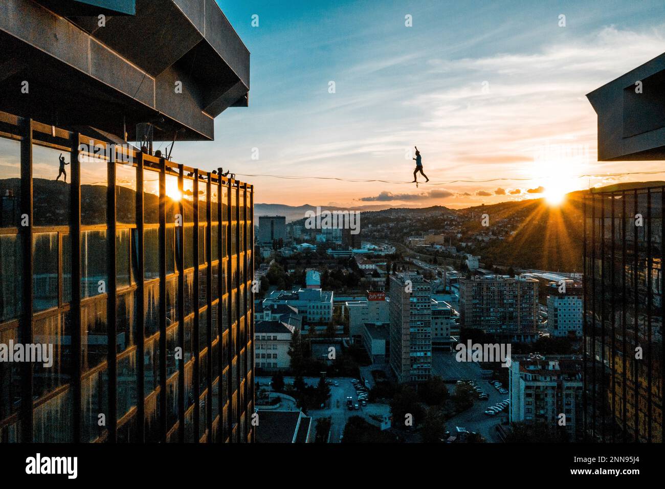 Estonian slackliner Jaan Roose performed a series of breathtaking tricks on a 28-metre-long slackline between the iconic Unitic skyscrapers in Sarajevo. Former parkour athlete Roose has been involved in slacklining for 11 years since he was 18 and has become a three-time world champion plus the only person able to do a double upside down somersault on a rope. // Jaan Roose of Estonia performs during the Unitic Towers Slacking in Sarajevo, Bosnia-Herzegovina on May 6, 2021. // Predrag Vuckovic / Red Bull Content Pool via AP Images // For more content, pictures and videos like this please go to  Stock Photo