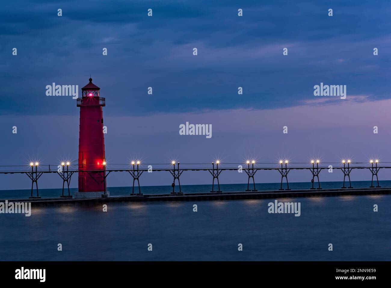 Grand Haven Lighthouse, South Pier, on Lake Michigan at sunset, Grand Haven, Ottawa Co., MI Stock Photo