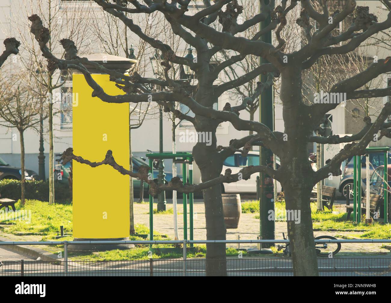 Empty advertising pillar on a city place with yellow free copy space, promotion mock up. Blank advertising panel Stock Photo