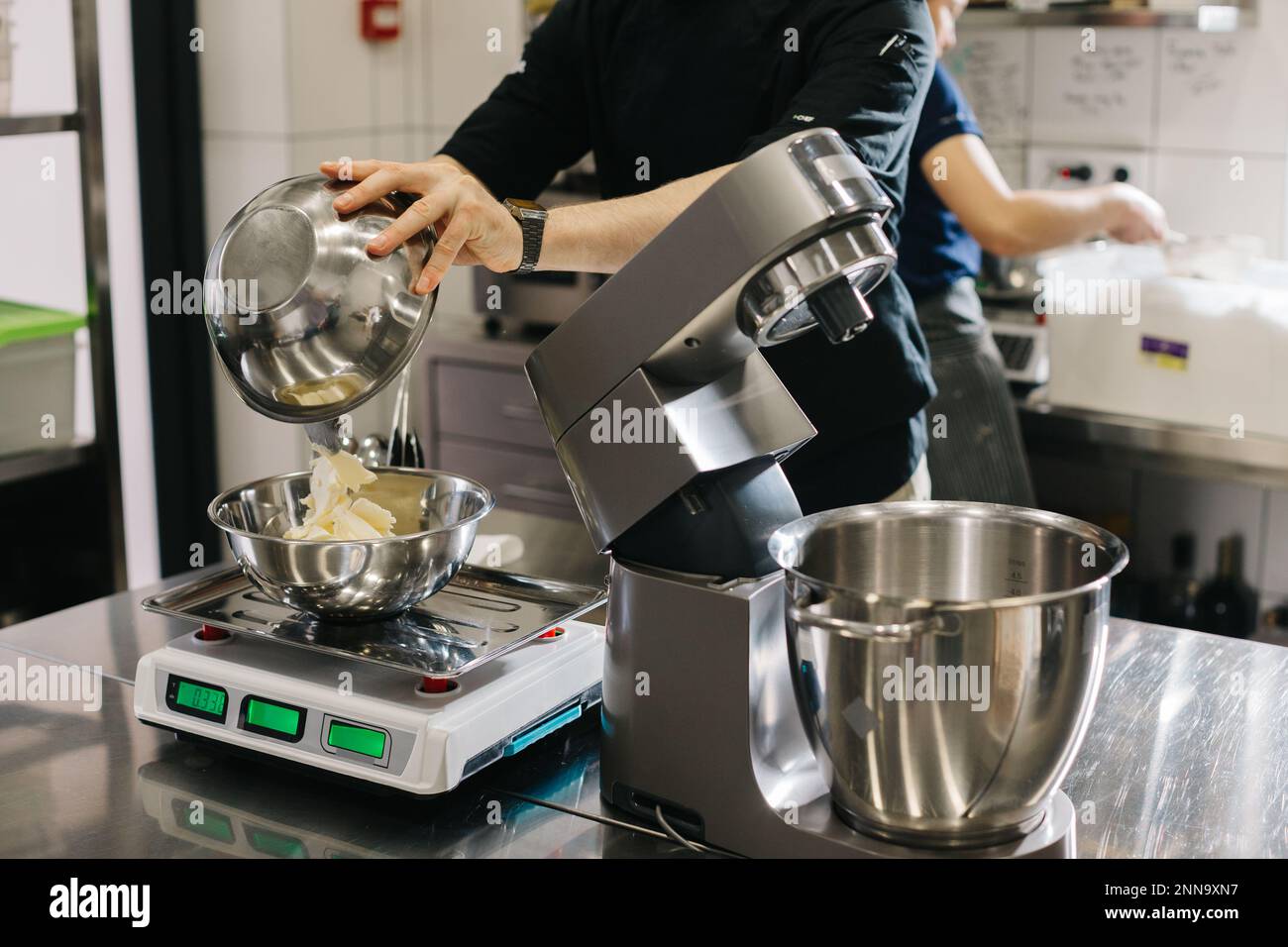 Making macarons. A silver kitchen table mixer kneads the dough for