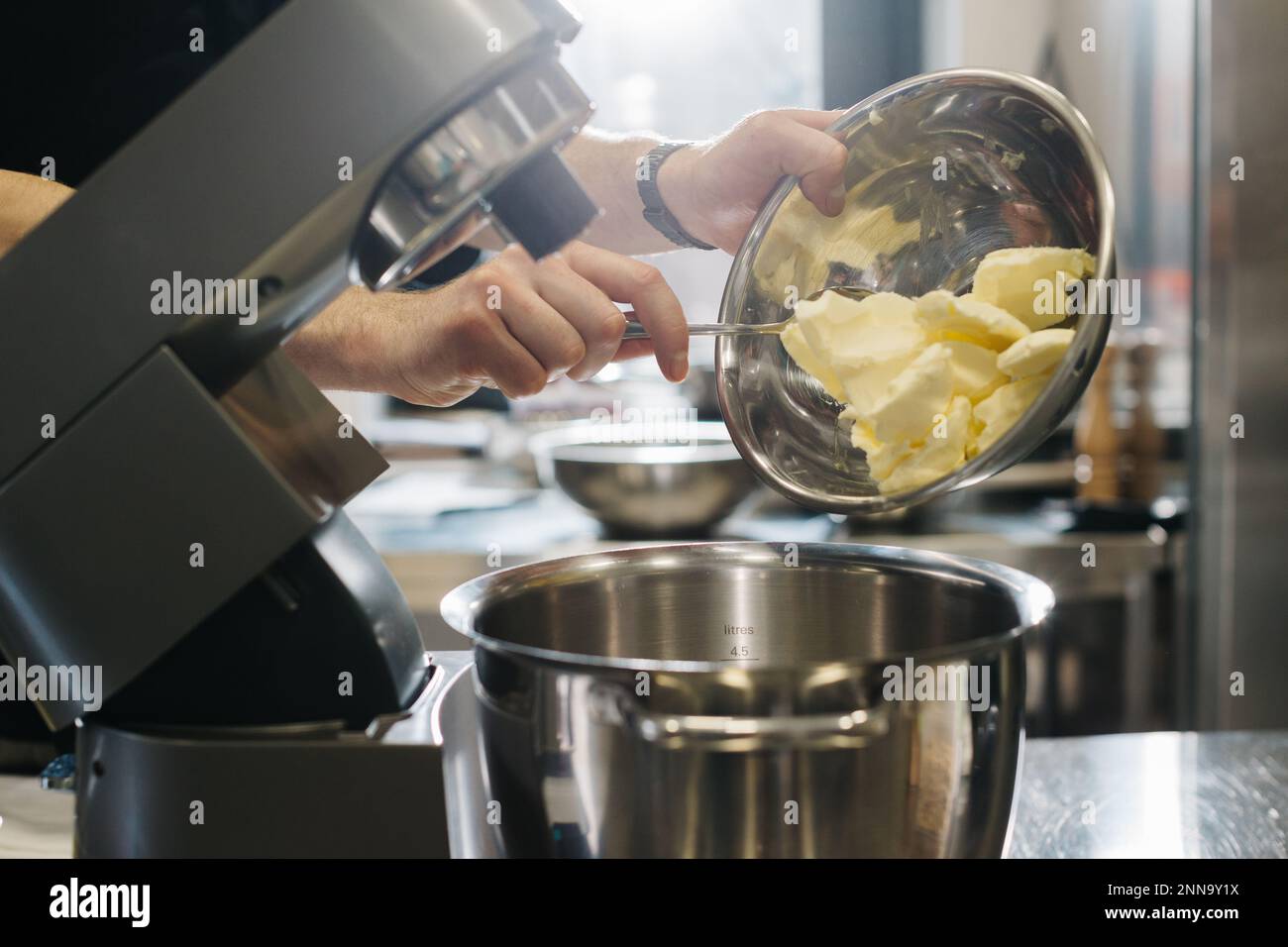 Making macarons. A silver kitchen table mixer kneads the dough for