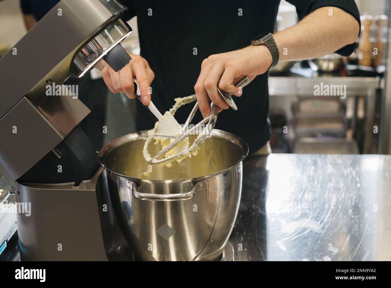 Making macarons. A silver kitchen table mixer kneads the dough for