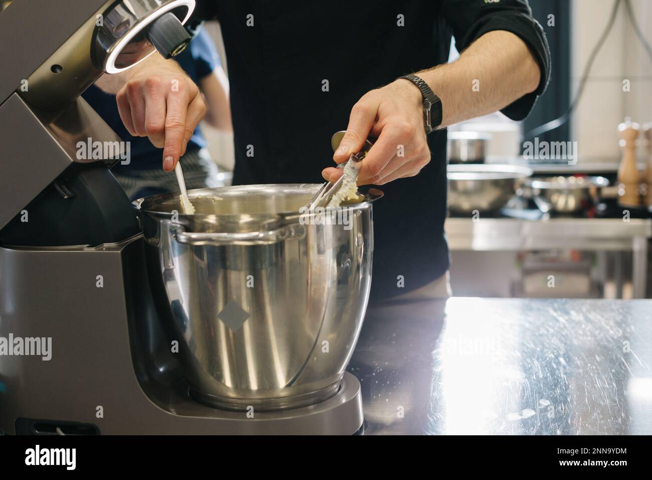 Making macarons. A silver kitchen table mixer kneads the dough for