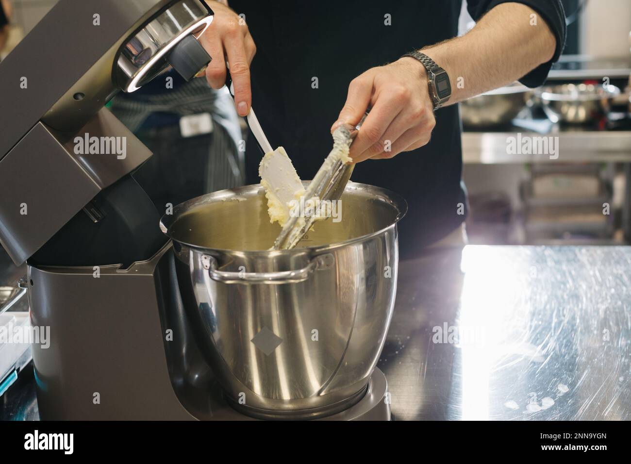 Making macarons. A silver kitchen table mixer kneads the dough for