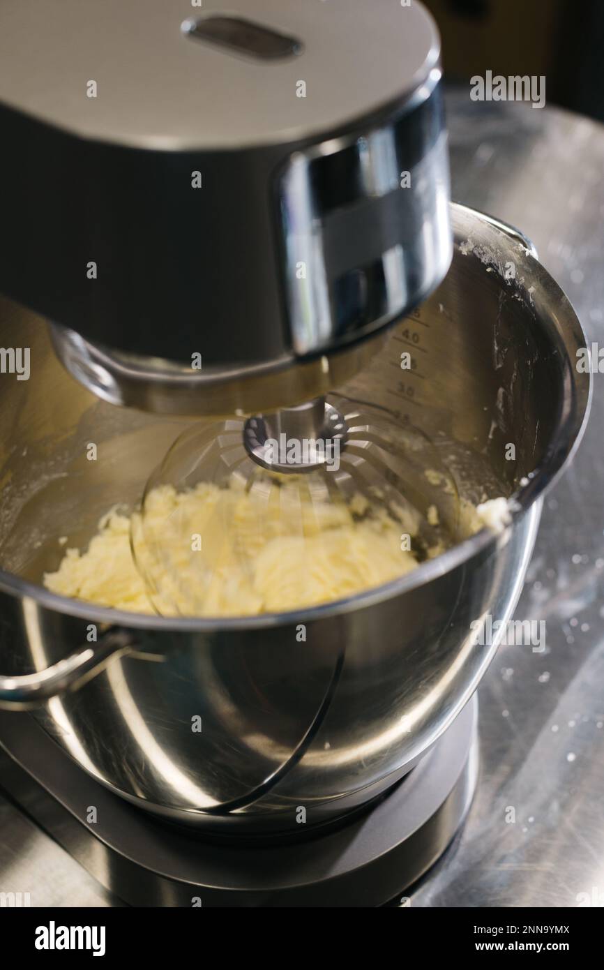 Making macarons. A silver kitchen table mixer kneads the dough for