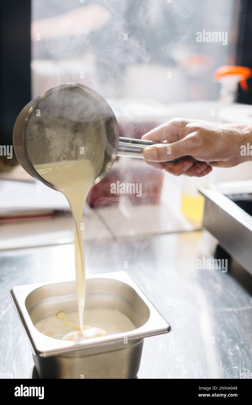 The process of making ganache, a filling for a pistachio croissant. The